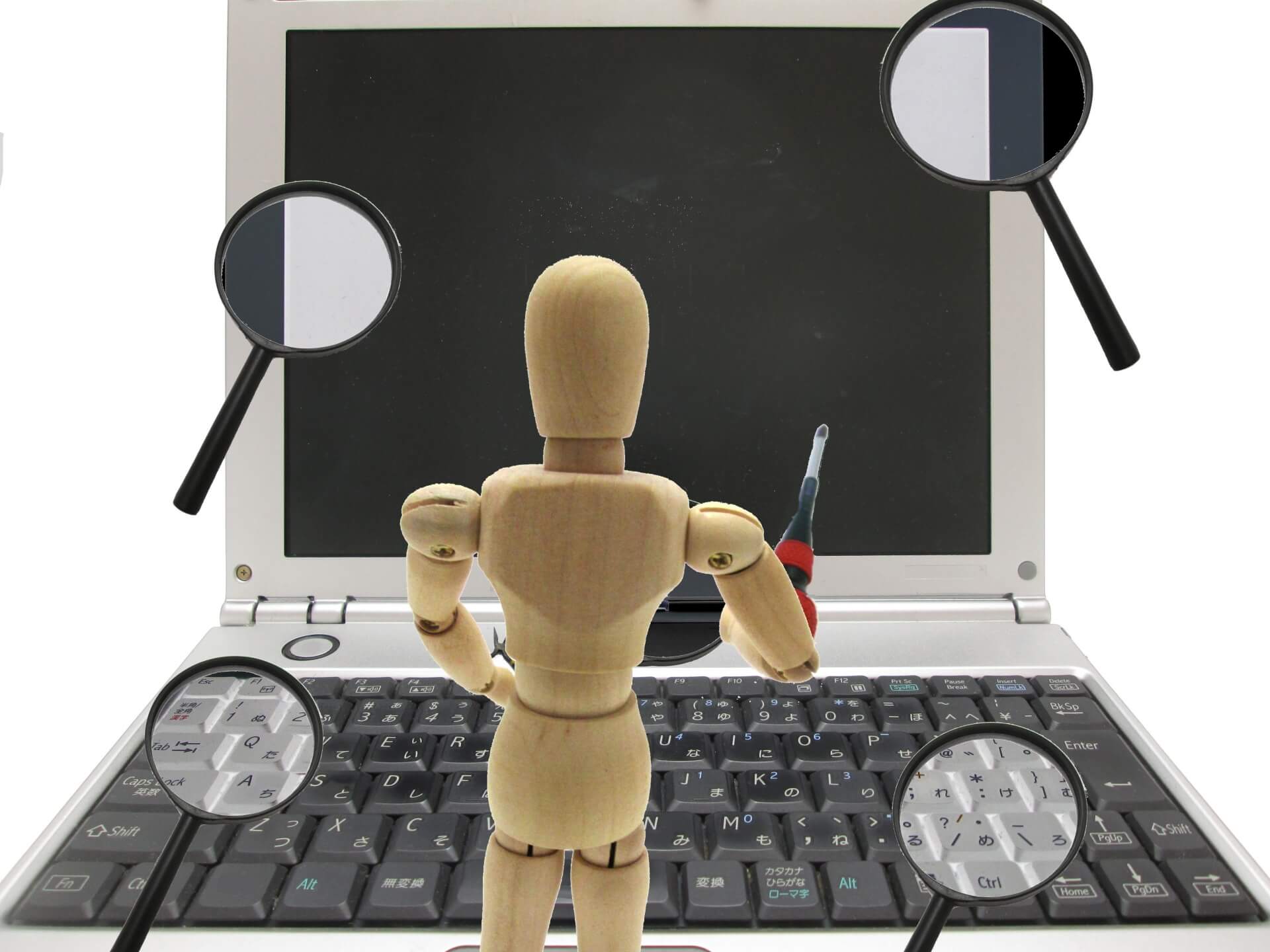 パソコンを修理している人形の画像